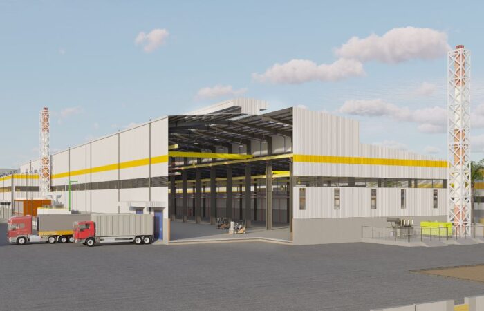 Industrial facility exterior with trucks and open bay, illustrating streamlined project execution phases